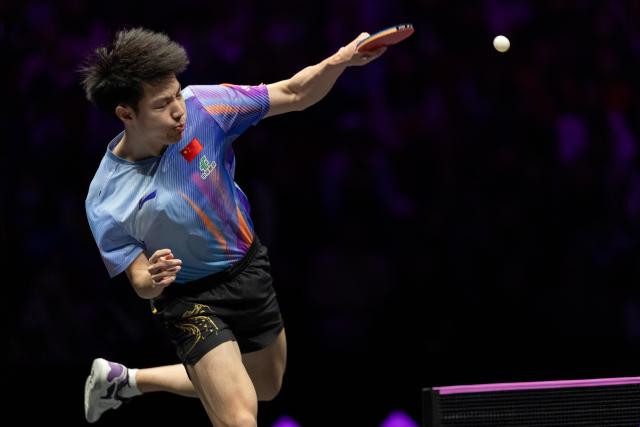 (260310) -- CHONGQING, March 10, 2026 (Xinhua) -- Huang Youzheng of China hits a return during the men's singles round of 32 match against Zhou Qihao of China at the WTT Champions Chongqing 2026 in southwest China's Chongqing, March 10, 2026. (Xinhua/Huang Wei)