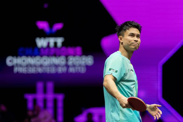 (260310) -- CHONGQING, March 10, 2026 (Xinhua) -- Zhou Qihao of China reacts during the men's singles round of 32 match against Huang Youzheng of China at the WTT Champions Chongqing 2026 in southwest China's Chongqing, March 10, 2026. (Xinhua/Huang Wei)