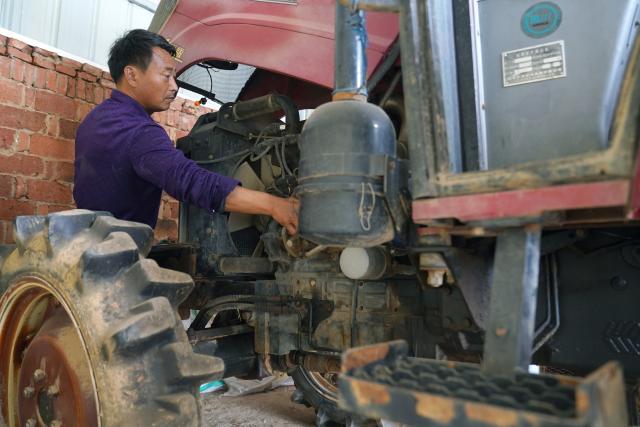 (260310) -- YUGAN, March 10, 2026 (Xinhua) -- Jiang Liangqing checks the condition of agro-machinery ahead of spring farming in Yugan County, east China's Jiangxi Province, on Feb. 27, 2026. Poyang Lake, China's largest freshwater lake and an extensive wetland, is a vital wintering and stopover site along the East Asian-Australasian Flyway. Every winter, thousands of Siberian cranes, a critically endangered species, gather in Yugan County, which lies to the southeast of the lake. 
   Decades ago, local villagers faced a dilemma. On the one hand, capturing or killing migratory birds was against the law. On the other hand, leaving the birds undisturbed could lead to serious crop losses. To reduce the damage, villagers around the lake often went to great lengths to drive birds away, using firecrackers, beating gongs, and setting up scarecrows.
   To address the problem, local authorities introduced a compensation mechanism. Villagers whose crops have been damaged in the course of wetland and migratory bird conservation can receive compensation. The policy has helped reduce crop losses for villagers while supporting bird conservation. As a result, more migratory birds now winter at Poyang Lake, and the local birdwatching economy has flourished.
   Jiang Liangqing, once troubled by the "bird dilemma," is now a bird guardian in Yugan County. "I have more than 100 mu (about 6.67 hectares) of rice fields, where migratory birds often come to forage," Jiang said. "It used to be a problem, but now I receive compensation after local authorities assess my crop losses."
   "Now I'm a bird guardian. I patrol the wetlands every day and share knowledge about bird conservation with tourists," Jiang said. Like him, many local villagers have joined conservation efforts, including raising ecological awareness and patrolling wetlands. (Xinhua/Wan Xiang)