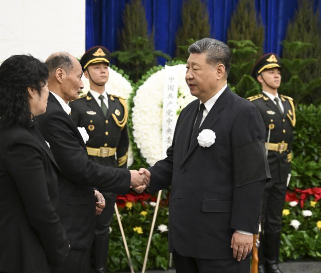 (260310) -- BEIJING, March 10, 2026 (Xinhua) -- Xi Jinping shakes hands with a family member of Song Ping to express deep condolences in Beijing, capital of China, March 10, 2026. The remains of Song Ping, a former senior official of the Communist Party of China (CPC) and the state, were cremated in Beijing on Tuesday. Xi Jinping, Li Qiang, Zhao Leji, Wang Huning, Cai Qi, Ding Xuexiang, Li Xi, Han Zheng and other leaders paid their final respects to Song at the Babaoshan Revolutionary Cemetery. Hu Jintao sent a wreath to express his condolences over Song's passing. (Xinhua/Xie Huanchi)