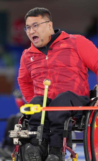 (260310) -- CORTINA D'AMPEZZO, March 10, 2026 (Xinhua) -- Wang Haitao of China reacts during the wheelchair curling mixed team round robin session 7 match between China and Canada at the Milan-Cortina 2026 Paralympic Winter Games in Cortina D'ampezzo, Italy, March 10, 2026. (Xinhua/Cai Yang)