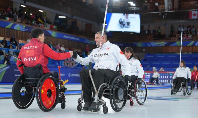 (260310) -- CORTINA D'AMPEZZO, March 10, 2026 (Xinhua) -- Athletes greet each other after the wheelchair curling mixed team round robin session 7 match between China and Canada at the Milan-Cortina 2026 Paralympic Winter Games in Cortina D'ampezzo, Italy, March 10, 2026. (Xinhua/Cai Yang)