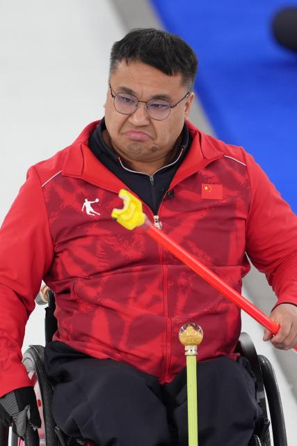 (260310) -- CORTINA D'AMPEZZO, March 10, 2026 (Xinhua) -- Wang Haitao of China reacts during the wheelchair curling mixed team round robin session 7 match between China and Canada at the Milan-Cortina 2026 Paralympic Winter Games in Cortina D'ampezzo, Italy, March 10, 2026. (Xinhua/Cai Yang)