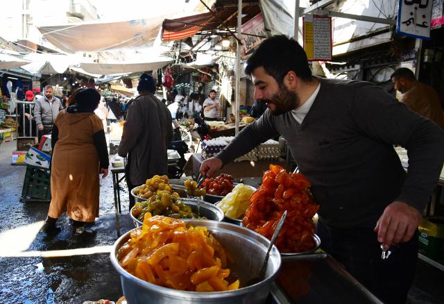 (260310) -- DAMASCUS, March 10, 2026 (Xinhua) -- A vendor sells food at a popular marketplace in Damascus, Syria, on March 10, 2026. (Photo by Ammar Safarjalani/Xinhua)