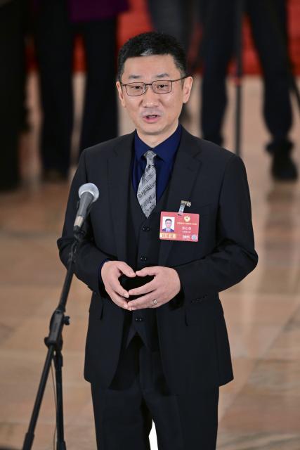 (260311) -- BEIJING, March 11, 2026 (Xinhua) -- Li Xincao, a member of the 14th National Committee of the Chinese People's Political Consultative Conference (CPPCC), attends a group interview ahead of the closing meeting of the fourth session of the 14th CPPCC National Committee at the Great Hall of the People in Beijing, capital of China, March 11, 2026. (Xinhua/Chen Yehua)