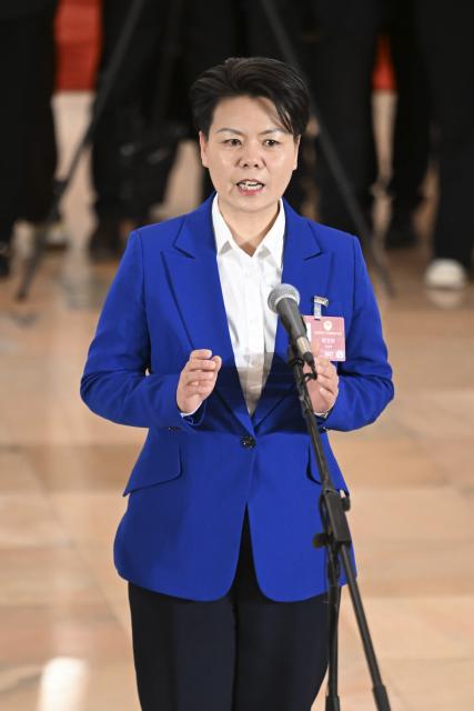 (260311) -- BEIJING, March 11, 2026 (Xinhua) -- Cheng Yuzhen, a member of the 14th National Committee of the Chinese People's Political Consultative Conference (CPPCC), attends a group interview ahead of the closing meeting of the fourth session of the 14th CPPCC National Committee at the Great Hall of the People in Beijing, capital of China, March 11, 2026. (Xinhua/Cao Yiming)