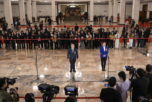 (260311) -- BEIJING, March 11, 2026 (Xinhua) -- Members of the 14th National Committee of the Chinese People's Political Consultative Conference (CPPCC) attend a group interview ahead of the closing meeting of the fourth session of the 14th CPPCC National Committee at the Great Hall of the People in Beijing, capital of China, March 11, 2026. (Xinhua/Cao Yiming)
