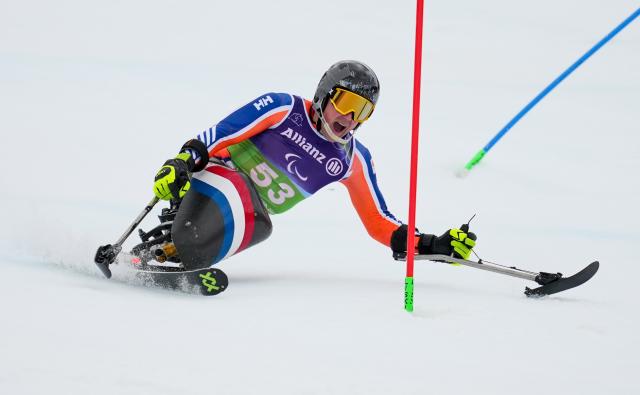 (260311) -- CORTINA D'AMPEZZO, March 11, 2026 (Xinhua) -- Niels de Langen of the Netherlands competes during the Para Alpine Skiing Men's Alpine Combined Sitting event at the Milan-Cortina 2026 Paralympic Winter Games in Cortina D'ampezzo, Italy, March 10, 2026. (Xinhua/Wang Kaiyan)