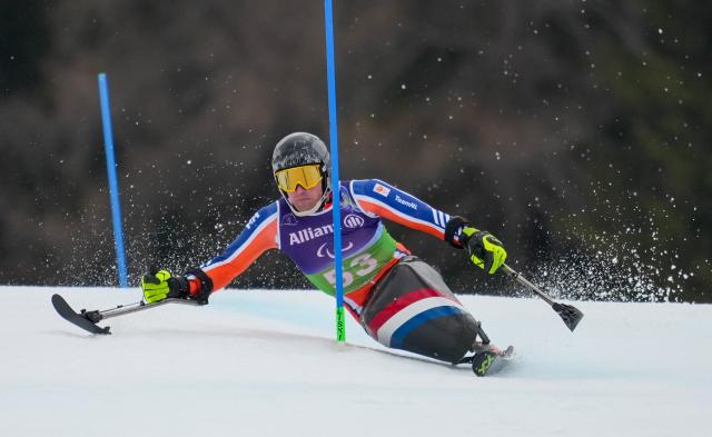 (260311) -- CORTINA D'AMPEZZO, March 11, 2026 (Xinhua) -- Niels de Langen of the Netherlands competes during the Para Alpine Skiing Men's Alpine Combined Sitting event at the Milan-Cortina 2026 Paralympic Winter Games in Cortina D'ampezzo, Italy, March 10, 2026. (Xinhua/Wang Kaiyan)