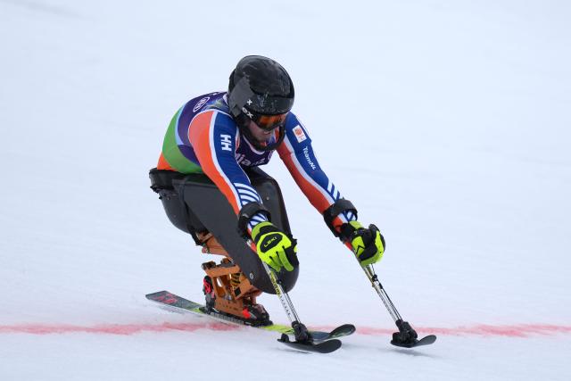 (260311) -- CORTINA D'AMPEZZO, March 11, 2026 (Xinhua) -- Jeroen Kampschreur of the Netherlands crosses the finish line during the Para Alpine Skiing Men's Alpine Combined Sitting event at the Milan-Cortina 2026 Paralympic Winter Games in Cortina D'ampezzo, Italy, March 10, 2026. (Xinhua/Lian Yi)