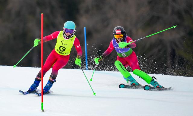 (260311) -- CORTINA D'AMPEZZO, March 11, 2026 (Xinhua) -- Veronika Aigner (R) of Austria and her guide Lilly Sammer compete during the para alpine skiing women's combined vision impaired event at the Milan-Cortina 2026 Paralympic Winter Games in Cortina D'ampezzo, Italy, March 10, 2026. (Xinhua/Wang Kaiyan)