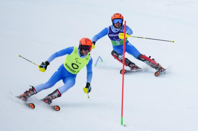 (260311) -- CORTINA D'AMPEZZO, March 11, 2026 (Xinhua) -- Giacomo Bertagnolli (R) and his guide Andrea Ravelli of Italy compete during the Para Alpine Skiing Men's Alpine Combined Vision Impaired event at the Milan-Cortina 2026 Paralympic Winter Games in Cortina D'ampezzo, Italy, March 10, 2026. (Xinhua/Wang Kaiyan)