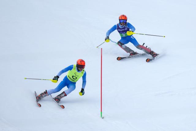 (260311) -- CORTINA D'AMPEZZO, March 11, 2026 (Xinhua) -- Giacomo Bertagnolli (R) and his guide Andrea Ravelli of Italy compete during the Para Alpine Skiing Men's Alpine Combined Vision Impaired event at the Milan-Cortina 2026 Paralympic Winter Games in Cortina D'ampezzo, Italy, March 10, 2026. (Xinhua/Lian Yi)