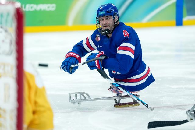 (260311) -- MILAN, March 11, 2026 (Xinhua) -- Brody Roybal of the United States scores during the Para Ice Hockey preliminary round match of Group A between the United States and China at the Milan-Cortina 2026 Paralympic Winter Games in Milan, Italy, March 10, 2026. (Xinhua/Li Jing)