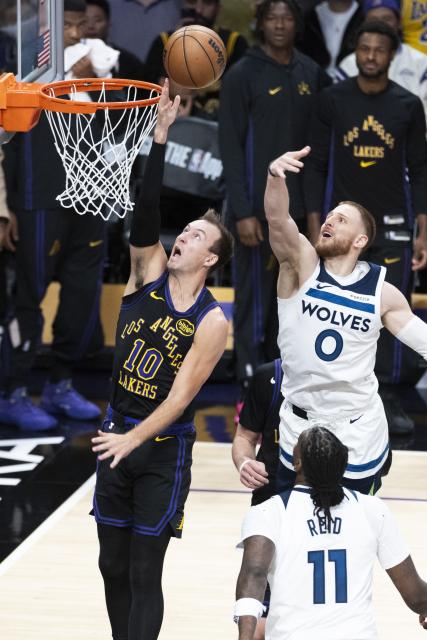 (260311) -- LOS ANGELES, March 11, 2026 (Xinhua) -- Los Angeles Lakers' Luke Kennard (L) goes up to the basket during the 2025-2026 NBA regular season game between Los Angeles Lakers and Minnesota Timberwolves in Los Angeles, the United States, March 10, 2026. (Photo by Ringo Chiu/Xinhua)