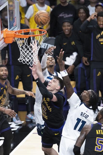 (260311) -- LOS ANGELES, March 11, 2026 (Xinhua) -- Los Angeles Lakers' Jake LaRavia (C) goes to the basket during the 2025-2026 NBA regular season game between Los Angeles Lakers and Minnesota Timberwolves in Los Angeles, the United States, March 10, 2026. (Photo by Ringo Chiu/Xinhua)