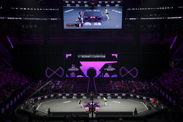 (260311) -- CHONGQING, March 11, 2026 (Xinhua) -- Wang Chuqin (L) and Jonathan Groth compete during the men's singles round of 32 match between Wang Chuqin of China and Jonathan Groth of Denmark at the WTT Champions Chongqing 2026 in southwest China's Chongqing, March 11, 2026. (Xinhua/Chen Cheng)