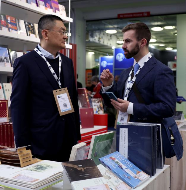 (260311) -- LONDON, March 11, 2026 (Xinhua) -- People talk at the China Pavilion of the 2026 London Book Fair in London, Britain, March 10, 2026.
  At Olympia London, where the 2026 London Book Fair opened Tuesday, the China pavilion stands out not merely for its expansive footprint, but for the comprehensive publishing ecosystem it showcases.
  The Chinese publishing delegation has arrived with an impressive portfolio of over 4,000 titles and a packed schedule of more than 40 events. Spanning the three-day fair, the agenda ranges from high-profile new book launches and author talks to rights exchanges and industry forums.
  TO GO WITH "Feature: Two-way street -- China's delegation highlights cultural synergy, tech fusion at London Book Fair" (Xinhua/Li Ying)