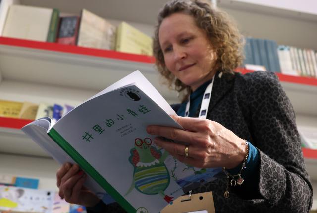 (260311) -- LONDON, March 11, 2026 (Xinhua) -- A woman reads at the China Pavilion of the 2026 London Book Fair in London, Britain, March 10, 2026.
  At Olympia London, where the 2026 London Book Fair opened Tuesday, the China pavilion stands out not merely for its expansive footprint, but for the comprehensive publishing ecosystem it showcases.
  The Chinese publishing delegation has arrived with an impressive portfolio of over 4,000 titles and a packed schedule of more than 40 events. Spanning the three-day fair, the agenda ranges from high-profile new book launches and author talks to rights exchanges and industry forums.
  TO GO WITH "Feature: Two-way street -- China's delegation highlights cultural synergy, tech fusion at London Book Fair" (Xinhua/Li Ying)