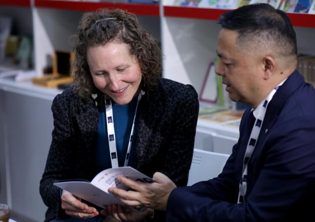 (260311) -- LONDON, March 11, 2026 (Xinhua) -- People talk at the China Pavilion of the 2026 London Book Fair in London, Britain, March 10, 2026.
  At Olympia London, where the 2026 London Book Fair opened Tuesday, the China pavilion stands out not merely for its expansive footprint, but for the comprehensive publishing ecosystem it showcases.
  The Chinese publishing delegation has arrived with an impressive portfolio of over 4,000 titles and a packed schedule of more than 40 events. Spanning the three-day fair, the agenda ranges from high-profile new book launches and author talks to rights exchanges and industry forums.
  TO GO WITH "Feature: Two-way street -- China's delegation highlights cultural synergy, tech fusion at London Book Fair" (Xinhua/Li Ying)