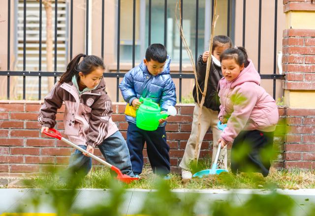 (260311) -- BEIJING, March 11, 2026 (Xinhua) -- Children take part in a tree planting event at a kindergarten in Laoling City, east China's Shandong Province, March 11, 2026. China designated March 12 as National Tree Planting Day in 1979, and launched a nationwide voluntary tree-planting campaign in 1981. With the 2026 National Tree Planting Day just around the corner, tree planting activities are held across the country to encourage more people to participate in afforestation work. (Photo by Jia Peng/Xinhua)