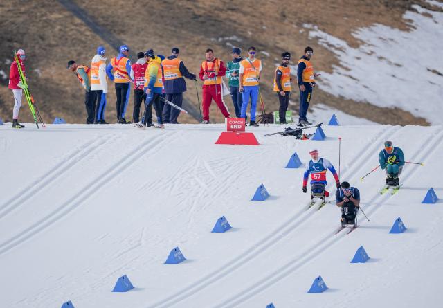 (260311) -- TESERO, March 11, 2026 (Xinhua) -- Ivan Golubkov (front L) of Russia competes during the final match of the men's 10km interval start sitting of Para Cross-Country Skiing at the Milan-Cortina 2026 Paralympic Winter Games in Tesero, Italy, March 11, 2026. (Xinhua/Lian Zhen)