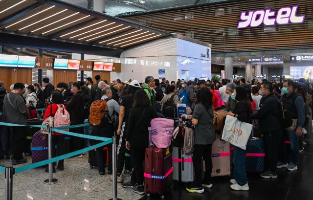 (260311) -- ISTANBUL, March 11, 2026 (Xinhua) -- Taiwan compatriots stranded in the Middle East queue to check in at Istanbul Airport in Istanbul, Türkiye, March 9, 2026. TO GO WITH "Over 70 stranded Taiwan compatriots return home from Middle East via Chinese mainland transit" (Xinhua/Liu Lei)