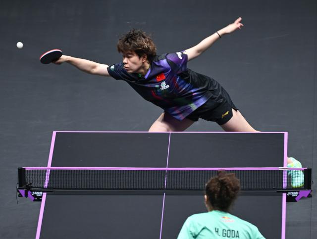 (260311) -- CHONGQING, March 11, 2026 (Xinhua) -- Wang Yidi of China hits a return during the women's singles round of 32 match against Hana Goda of Egypt at the WTT Champions Chongqing 2026 in southwest China's Chongqing, March 11, 2026. (Xinhua/Chen Cheng)