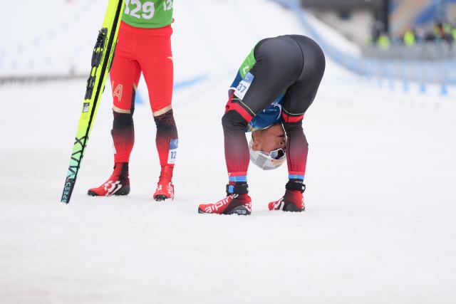 (260311) -- TESERO, March 11, 2026 (Xinhua) -- Huang Lingxin of China wipes his face after the final match of the men's 10km interval start classic standing of Para Cross-Country Skiing at the Milan-Cortina 2026 Paralympic Winter Games in Tesero, Italy, March 11, 2026. (Xinhua/Lian Zhen)