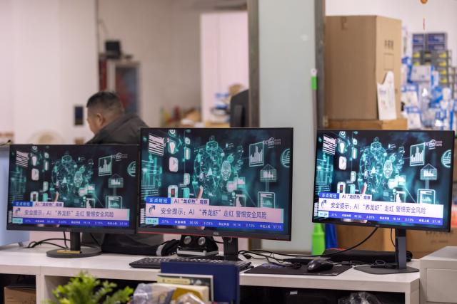 (260311) -- BEIJING, March 11, 2026 (Xinhua) -- This photo taken on March 11, 2026 shows computer screens displaying a news report on the open-source AI agent OpenClaw at a shopping center for digital gadgets in Wuxing District of Huzhou City, east China's Zhejiang Province. "Raising lobster" and one-person companies (OPCs), which have sparked heated discussions in China's AI community and among the public, are also hot topics at the country's ongoing "two sessions" this year.
   The term "raising lobster" originated from the open-source AI agent OpenClaw, which uses a red lobster as its icon. It has since become a buzzword, adopted by Chinese users to describe the process of setting up and training this smart assistant. 
   TO GO WITH "Economic Watch: 'Claw-powered' one-person companies become hot topic at China's 'two sessions'" (Photo by Yi Fan/Xinhua)