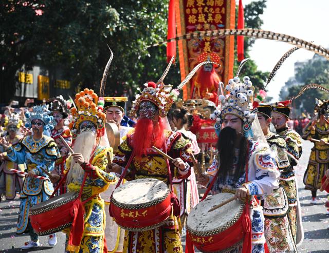 (260311) -- JIEYANG, March 11, 2026 (Xinhua) -- This photo taken on March 11, 2026 shows a Yingge dance, or "dance to the hero's song," during the Chenghuang temple fair in Jieyang, south China's Guangdong Province. The Chenghuang temple fair, held on the 23rd day of the first month on the traditional Chinese calendar, is one of the major traditional folk cultural events in Jieyang. (Xinhua/Deng Hua)