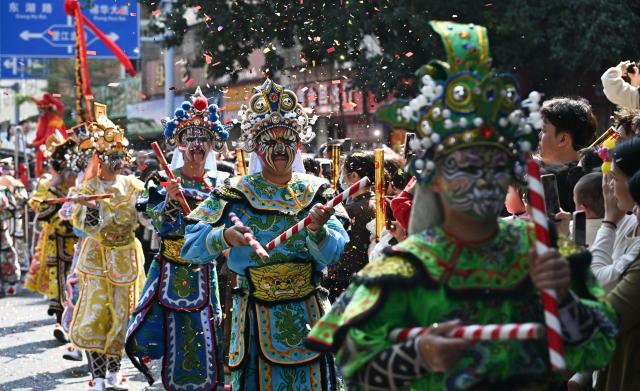(260311) -- JIEYANG, March 11, 2026 (Xinhua) -- This photo taken on March 11, 2026 shows a Yingge dance, or "dance to the hero's song," during the Chenghuang temple fair in Jieyang, south China's Guangdong Province. The Chenghuang temple fair, held on the 23rd day of the first month on the traditional Chinese calendar, is one of the major traditional folk cultural events in Jieyang. (Xinhua/Deng Hua)