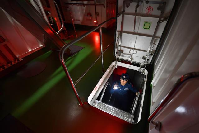 (260311) -- SOUTH CHINA SEA, March 11, 2026 (Xinhua) -- A law enforcer patrols aboard the China Coast Guard (CCG) vessel Sandu in the South China Sea, March 8, 2026. The CCG vessel Sandu conducted patrols in the South China Sea to safeguard China's territorial sovereignty and maritime rights and interests. (Xinhua/Mao Jun)