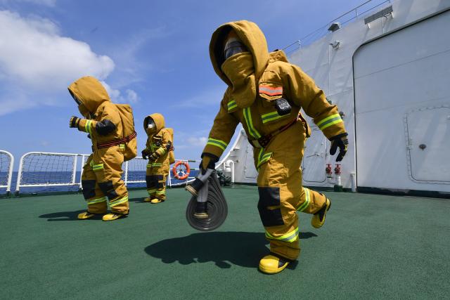 (260311) -- SOUTH CHINA SEA, March 11, 2026 (Xinhua) -- Law enforcers conduct firefighting training aboard the China Coast Guard (CCG) vessel Sandu in the South China Sea, March 8, 2026. The CCG vessel Sandu conducted patrols in the South China Sea to safeguard China's territorial sovereignty and maritime rights and interests. (Xinhua/He Xinyuan)
