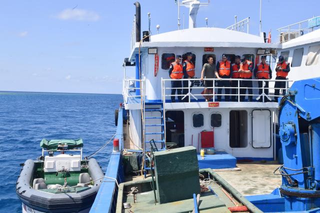 (260311) -- SOUTH CHINA SEA, March 11, 2026 (Xinhua) -- Law enforcers of the China Coast Guard (CCG) vessel Sandu visit a fishing boat in the South China Sea, March 4, 2026. The CCG vessel Sandu conducted patrols in the South China Sea to safeguard China's territorial sovereignty and maritime rights and interests. (Xinhua/Mao Jun)