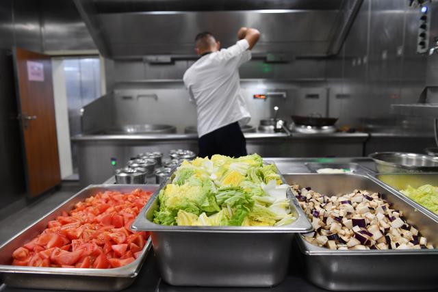 (260311) -- SOUTH CHINA SEA, March 11, 2026 (Xinhua) -- A law enforcer prepares dinner aboard the China Coast Guard (CCG) vessel Sandu in the South China Sea, March 8, 2026. The CCG vessel Sandu conducted patrols in the South China Sea to safeguard China's territorial sovereignty and maritime rights and interests. (Xinhua/Mao Jun)