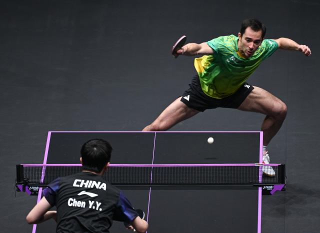 (260311) -- CHONGQING, March 11, 2026 (Xinhua) -- Hugo Calderano of Brazil hits a return during the men's singles round of 32 match against Chen Yuanyu of China at the WTT Champions Chongqing 2026 in southwest China's Chongqing, March 11, 2026. (Xinhua/Chen Cheng)