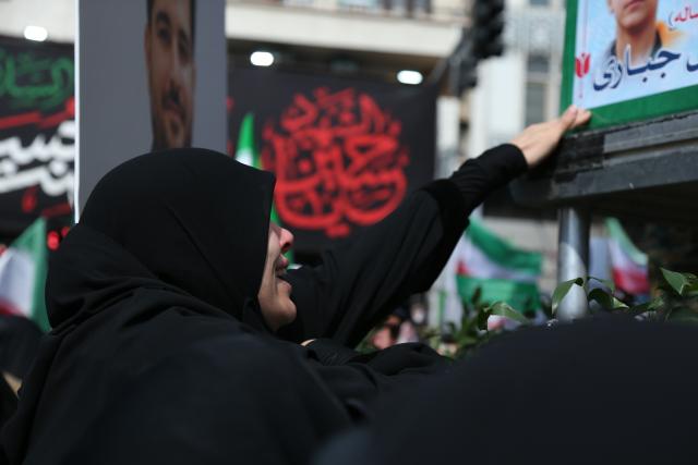 (260311) -- TEHRAN, March 11, 2026 (Xinhua) -- A woman attends a funeral held for Iranian high-ranking military commanders killed during strikes launched by the United States and Israel against Iran in Tehran, Iran, March 11, 2026. (Xinhua/Shadati)