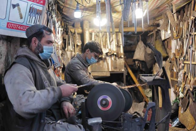 (260311) -- KABUL, March 11, 2026 (Xinhua) -- Vendors make ironware in a bazaar in Kabul, Afghanistan, on March 11, 2026. (Xinhua/Li Ang)