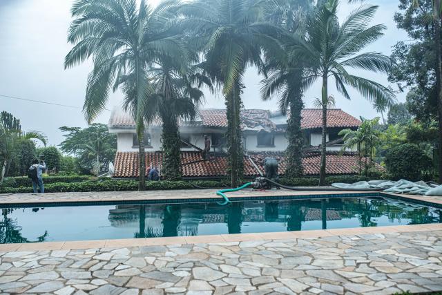 (260311) -- GOMA, March 11, 2026 (Xinhua) -- Rescue workers put out fire after a drone attack in Goma, eastern Democratic Republic of the Congo (DRC), on March 11, 2026. Explosions were heard on Wednesday morning. The March 23 Movement (M23) rebel group attributed a drone strike to the Congolese government's military forces. According to a provisional toll released by M23, three people were killed, including a French national working for the United Nations Children's Fund. (Str/Xinhua)