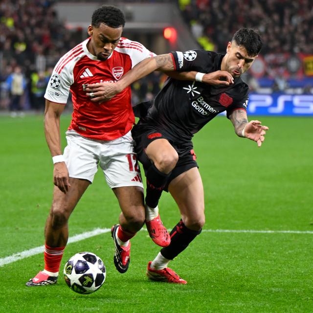 (260312) -- LEVERKUSEN, March 12, 2026 (Xinhua) -- Exequiel Palacios (R) of Bayer 04 Leverkusen vies with Jurrien Timber of Arsenal during the UEFA Champions League round of 16 first leg match between Bayer 04 Leverkusen and Arsenal in Leverkusen, Germany, March 11, 2026. (Photo by Ulrich Hufnagel/Xinhua)