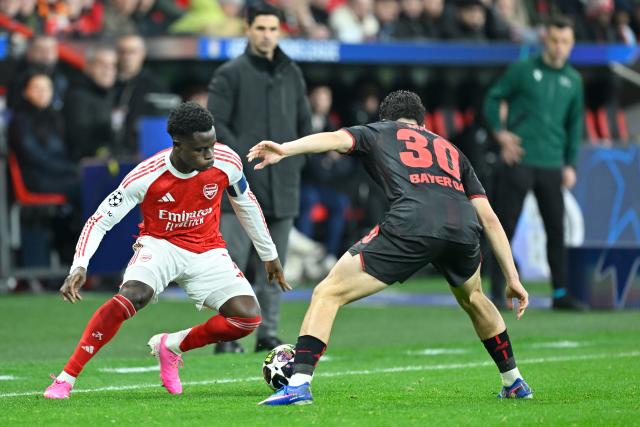 (260312) -- LEVERKUSEN, March 12, 2026 (Xinhua) -- Ibrahim Maza (R) of Bayer 04 Leverkusen vies with Bukayo Saka of Arsenal during the UEFA Champions League round of 16 first leg match between Bayer 04 Leverkusen and Arsenal in Leverkusen, Germany, March 11, 2026. (Photo by Ulrich Hufnagel/Xinhua)