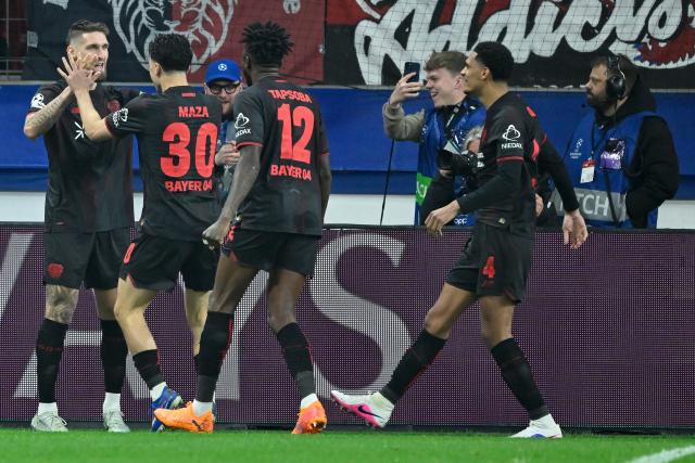 (260312) -- LEVERKUSEN, March 12, 2026 (Xinhua) -- Players of Bayer 04 Leverkusen celebrate scoring during the UEFA Champions League round of 16 first leg match between Bayer 04 Leverkusen and Arsenal in Leverkusen, Germany, March 11, 2026. (Photo by Ulrich Hufnagel/Xinhua)