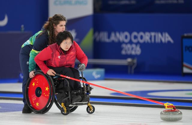 (260312) -- CORTINA D'AMPEZZO, March 12, 2026 (Xinhua) -- Wang Meng of China competes during the wheelchair curling mixed doubles gold medal game between China and South Korea at the Milan-Cortina 2026 Paralympic Winter Games in Cortina D'ampezzo, Italy, March 11, 2026. (Xinhua/Wang Kaiyan)