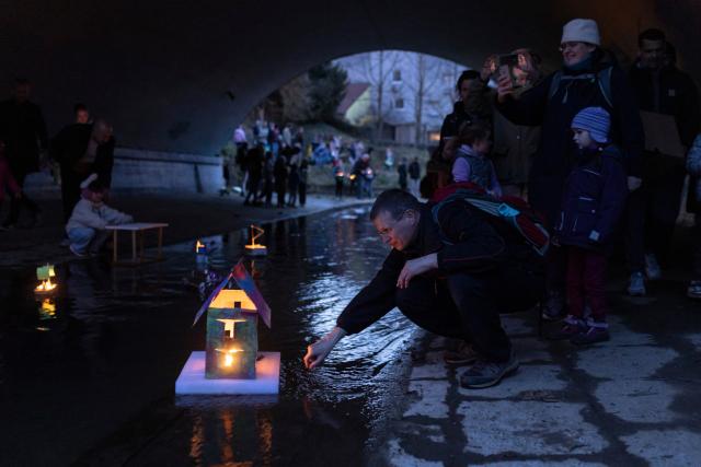 (260312) -- LJUBLJANA, March 12, 2026 (Xinhua) -- A man releases a float on a stream to celebrate the arrival of spring in Ljubljana, Slovenia, March 11, 2026. According to the Slovenian old calendar, March 12 marks the start of spring. It is a local tradition to send off floats downstream on March 11 to celebrate spring's arrival. (Photo by Zeljko Stevanic/Xinhua)