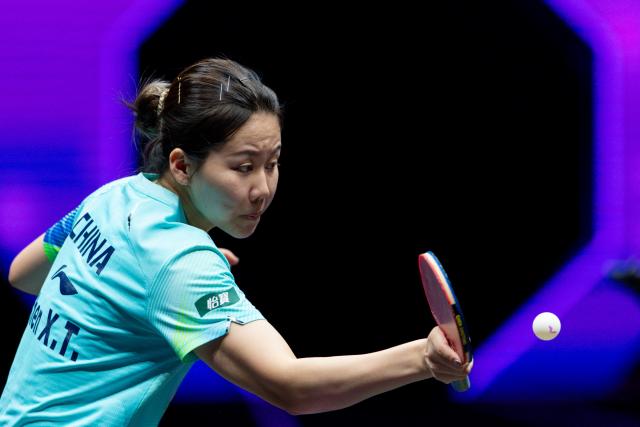 (260312) -- CHONGQING, March 12, 2026 (Xinhua) -- Chen Xingtong hits a return during the women's singles round of 32 match between Chen Xingtong of China and Sofia Polcanova of Austria at the WTT Champions Chongqing 2026 in southwest China's Chongqing, March 12, 2026. (Xinhua/Huang Wei)