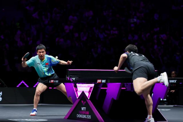 (260312) -- CHONGQING, March 12, 2026 (Xinhua) -- Xiang Peng (L) hits a return during the men's singles round of 32 match between Liang Jingkun of China and Xiang Peng of China at the WTT Champions Chongqing 2026 in southwest China's Chongqing, March 12, 2026. (Xinhua/Huang Wei)