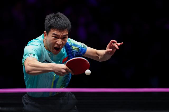 (260312) -- CHONGQING, March 12, 2026 (Xinhua) -- Xiang Peng hits a return during the men's singles round of 32 match between Liang Jingkun of China and Xiang Peng of China at the WTT Champions Chongqing 2026 in southwest China's Chongqing, March 12, 2026. (Xinhua/Huang Wei)
