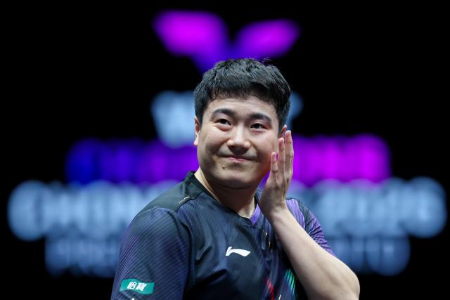 (260312) -- CHONGQING, March 12, 2026 (Xinhua) -- Liang Jingkun reacts during the men's singles round of 32 match between Liang Jingkun of China and Xiang Peng of China at the WTT Champions Chongqing 2026 in southwest China's Chongqing, March 12, 2026. (Xinhua/Huang Wei)