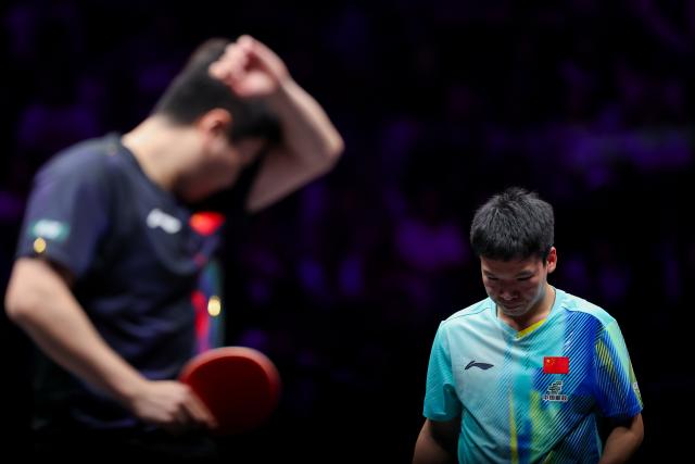 (260312) -- CHONGQING, March 12, 2026 (Xinhua) -- Xiang Peng (R) reacts during the men's singles round of 32 match between Liang Jingkun of China and Xiang Peng of China at the WTT Champions Chongqing 2026 in southwest China's Chongqing, March 12, 2026. (Xinhua/Huang Wei)